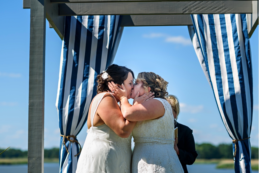 Two brides have their first kiss as a newly married couple.